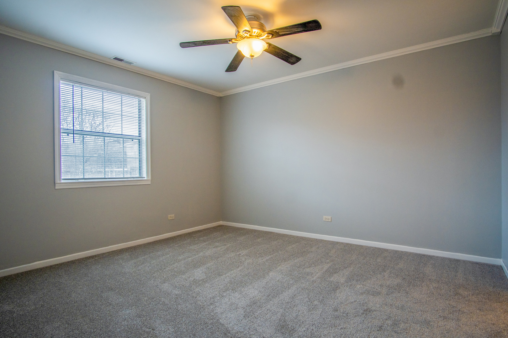 15 Gant Circle, Unit E Streamwood, IL 60107 - Photo 10 of 21 an empty room with a window and a fan