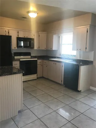 a kitchen with stainless steel appliances granite countertop a sink and a stove