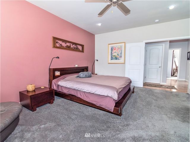a bedroom with a bed and a chandelier