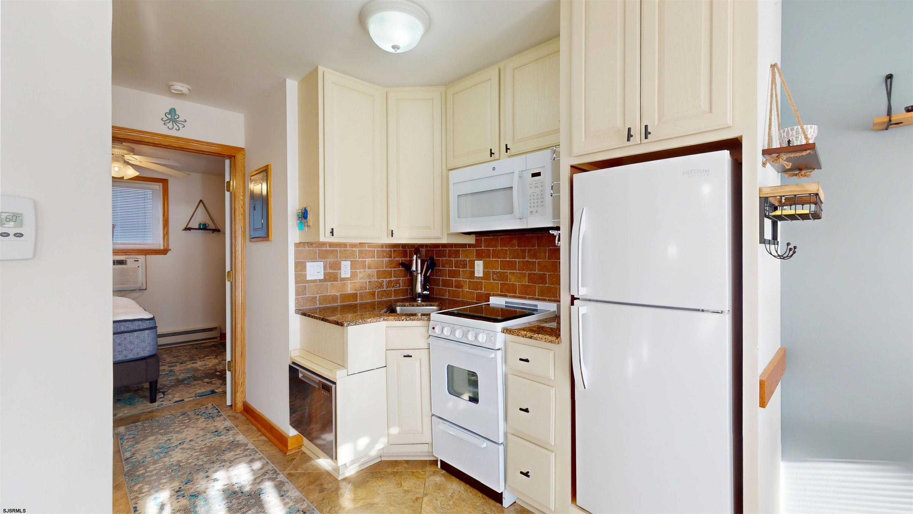 719 East Brigantine Avenue, Unit 1A Brigantine, NJ 08203 - Photo 13 of 37 a kitchen with stainless steel appliances a refrigerator sink and cabinets