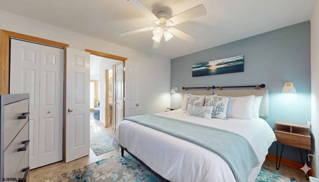 719 East Brigantine Avenue, Unit 1A Brigantine, NJ 08203 - Photo 16 of 37 a bedroom with a bed and a chandelier