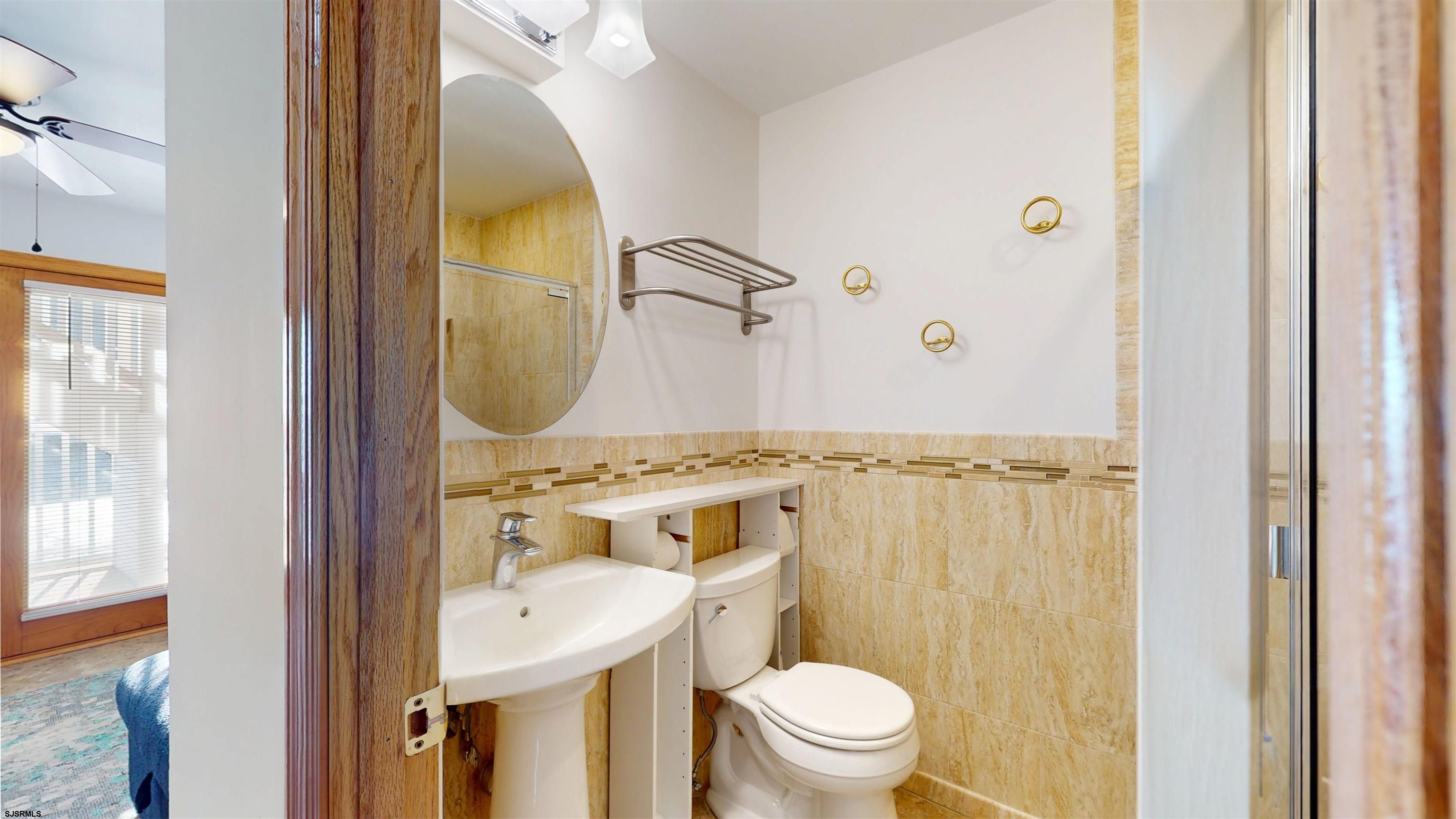 719 East Brigantine Avenue, Unit 1A Brigantine, NJ 08203 - Photo 4 of 37 a bathroom with a sink mirror toilet and shower
