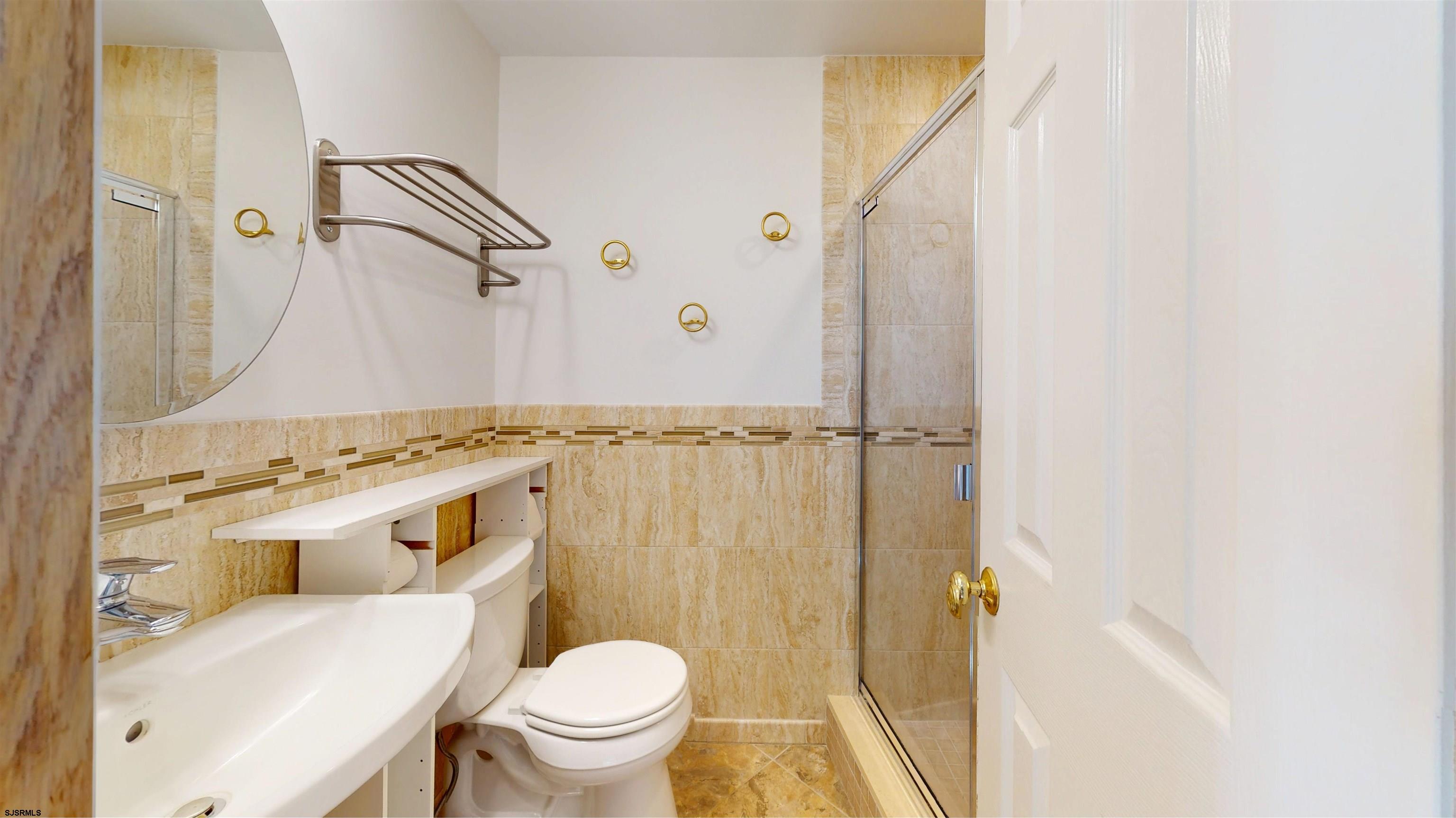719 East Brigantine Avenue, Unit 1A Brigantine, NJ 08203 - Photo 5 of 37 a bathroom with a sink a toilet and shower