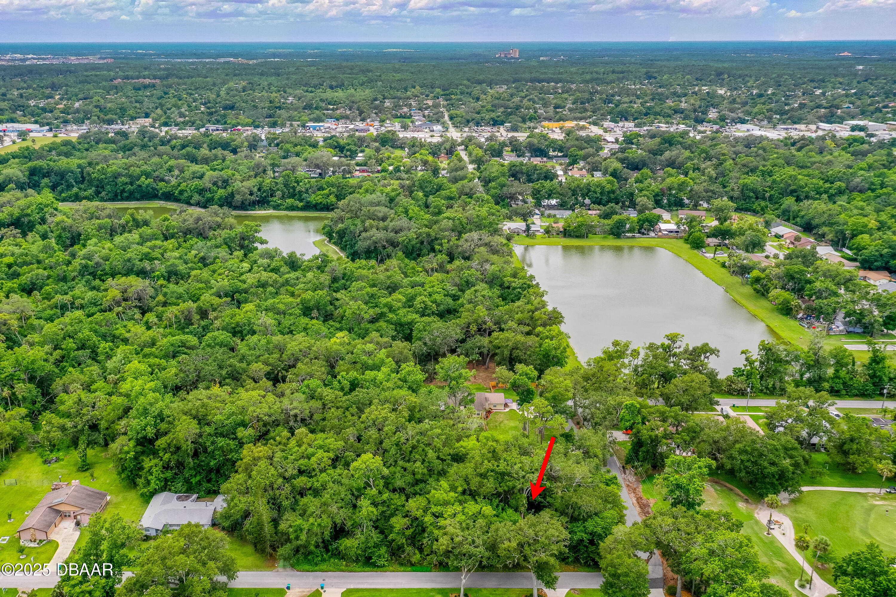 1 Timber Trail Holly Hill, FL 32174 - Photo 6 of 7 a view of lake with residential houses with outdoor space and swimming pool