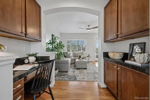 a kitchen with stainless steel appliances granite countertop a stove a sink dishwasher and cabinets with wooden floor