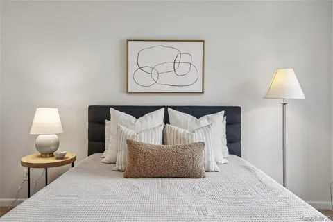 a bedroom with a bed and lamp