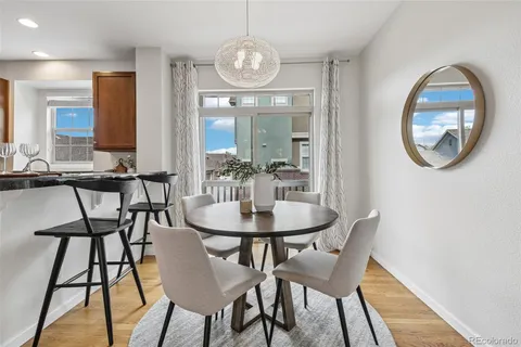 a view of a dining room with furniture and a chandelier