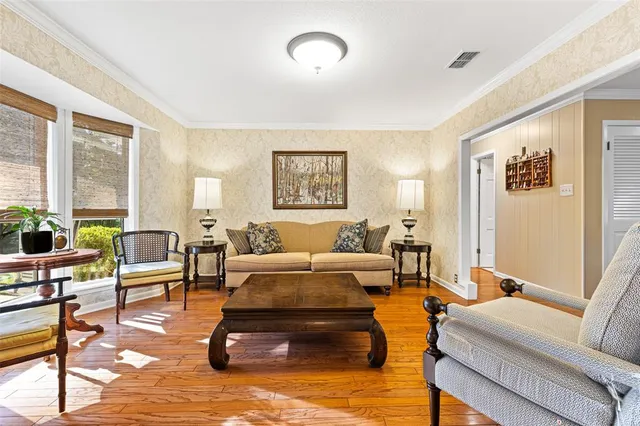 a view of a porch with chairs and potted plants