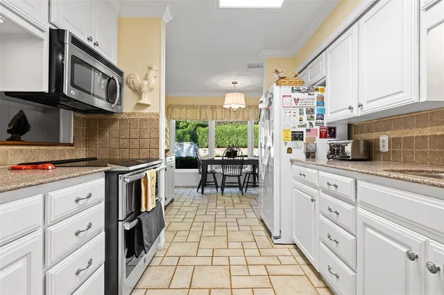 a kitchen with stainless steel appliances and cabinets