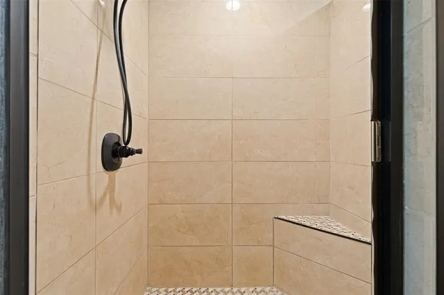 a bathroom with a double vanity sink mirror and shower