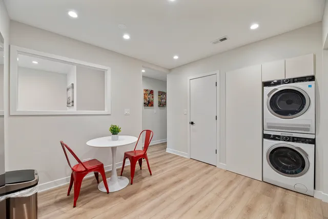 a view of a dining room with furniture a rug and a chandelier