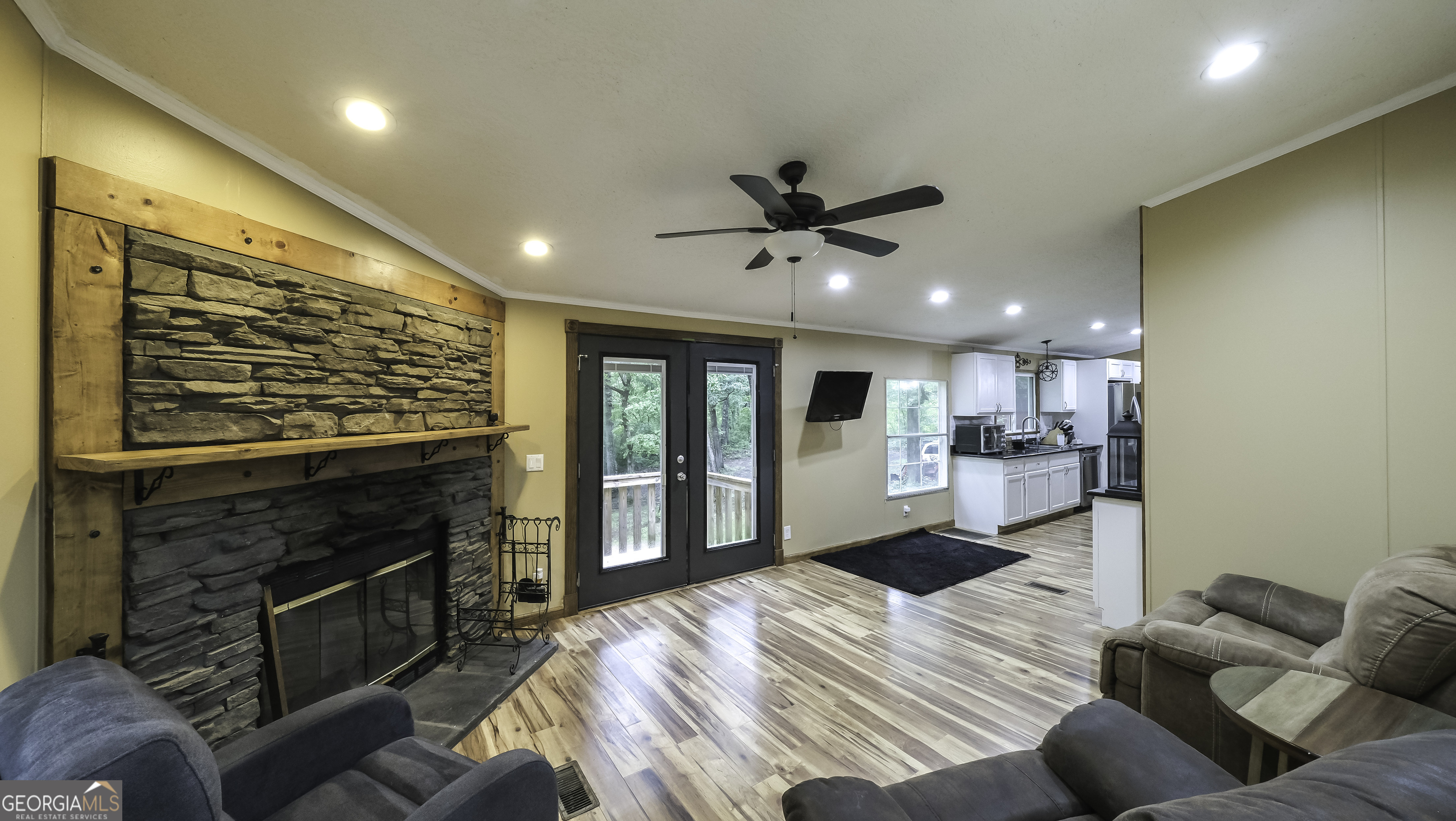 91 Holder Road Temple, GA 30179 - Photo 4 of 40 a bedroom with furniture a flat screen tv and a fireplace