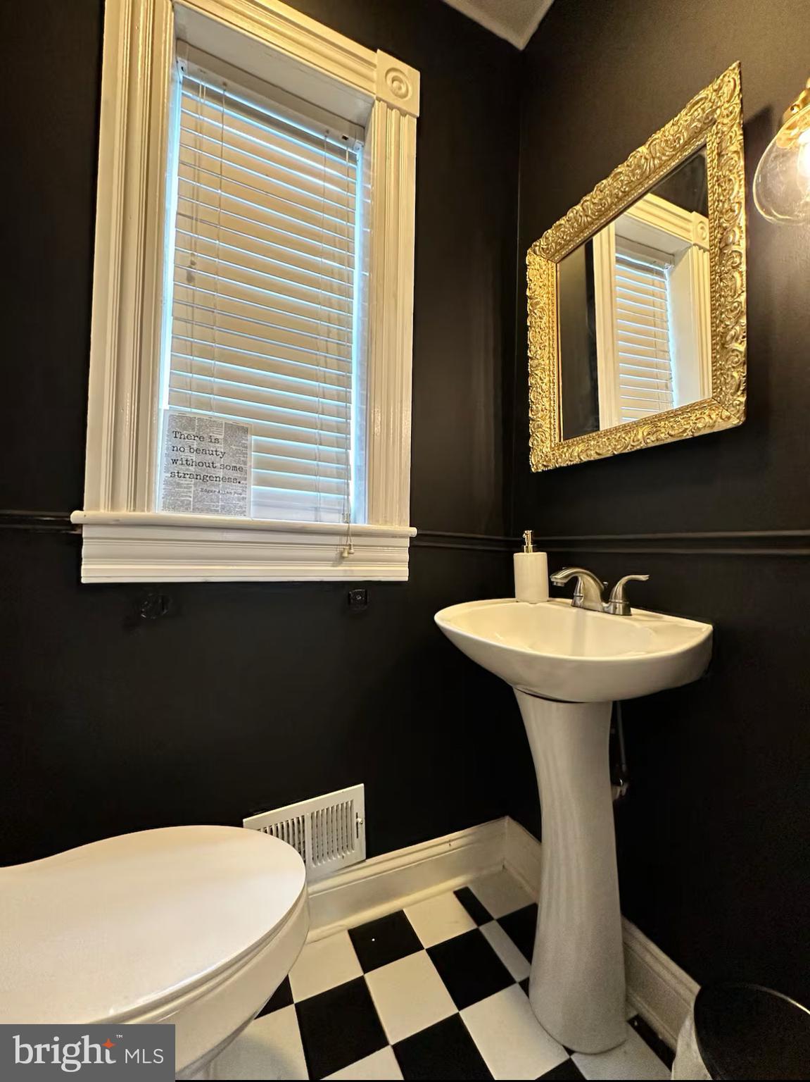 2112 Cambridge Street Baltimore, MD 21231 - Photo 11 of 20 a bathroom with a sink a toilet a mirror and shower