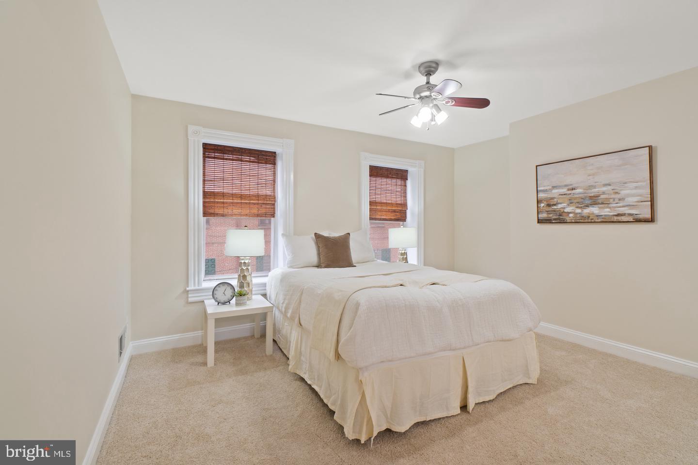 2112 Cambridge Street Baltimore, MD 21231 - Photo 13 of 20 a bedroom with a bed and a chandelier