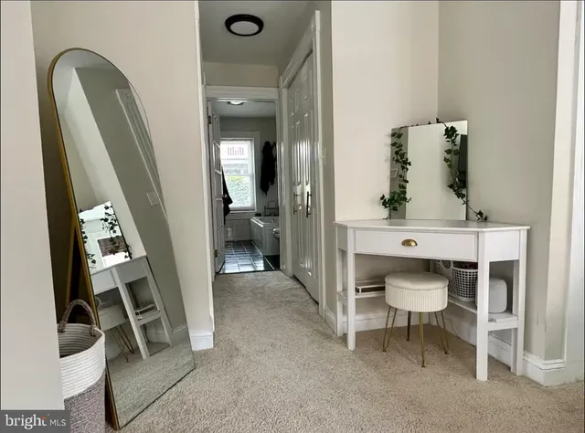 a view of hall way with furniture and staircase