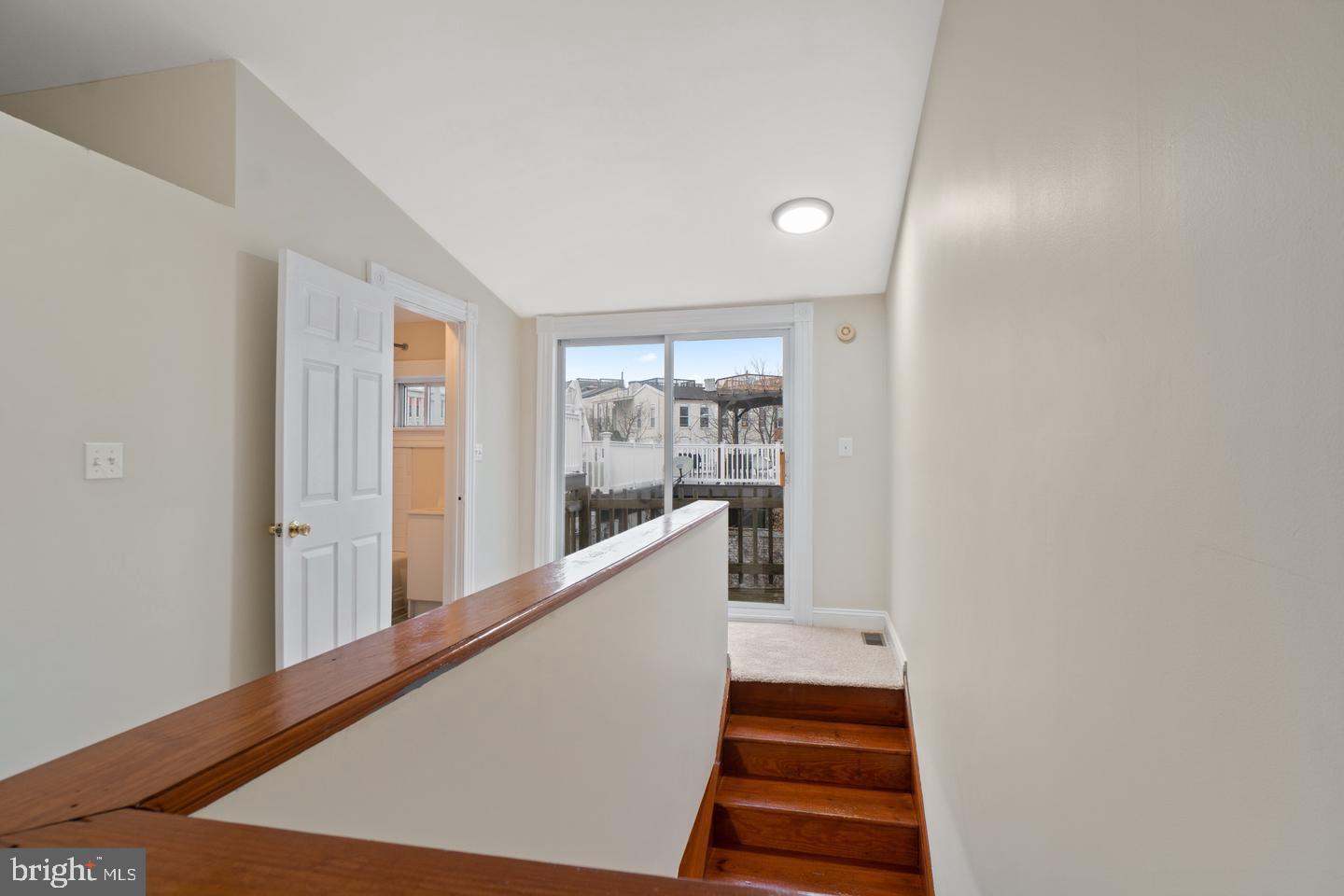 2112 Cambridge Street Baltimore, MD 21231 - Photo 17 of 20 a view of a hallway with wooden floor and staircase