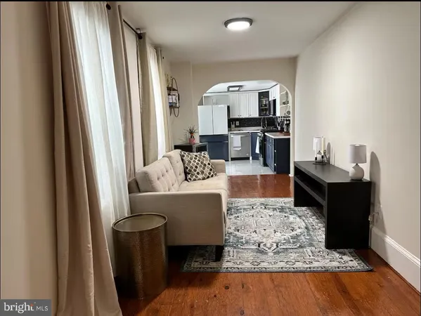 a living room with furniture and a rug