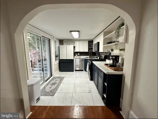 a kitchen with stainless steel appliances granite countertop a stove a sink dishwasher and a refrigerator