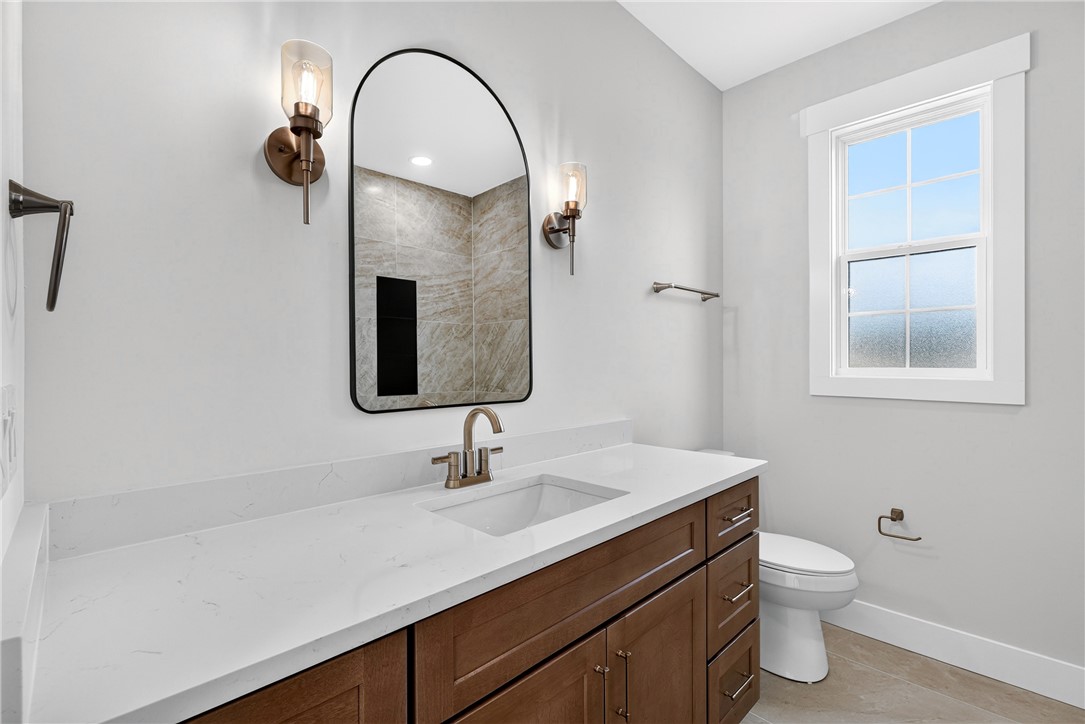 414 Blume Road Anderson, SC 29625 - Photo 9 of 50 Clean lines and stone counters highlight this refined powder room featuring a wood vanity.