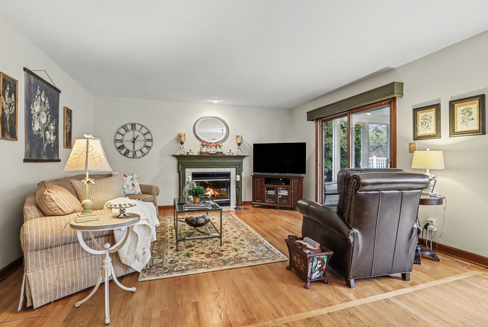 570 Violet Lane Batavia, IL 60510 - Photo 13 of 28 a living room with furniture a fireplace and a flat screen tv