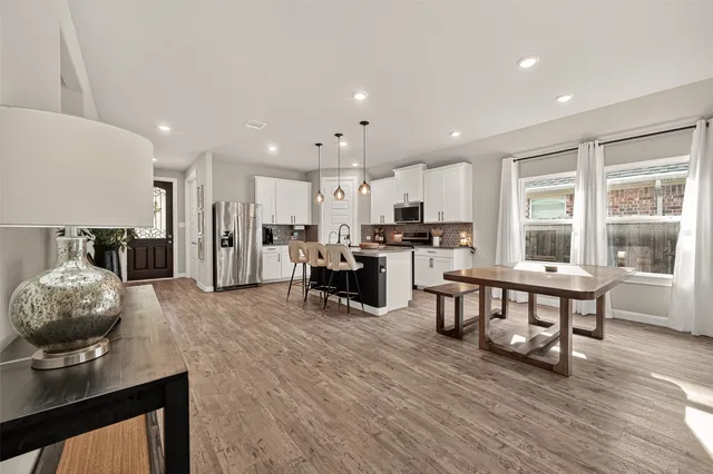 a living room with furniture and kitchen view