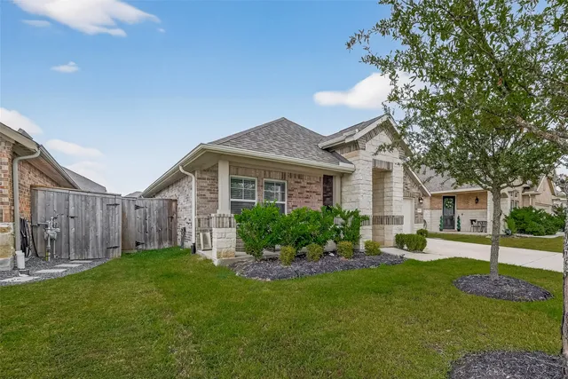 a view of a house with a yard and garden