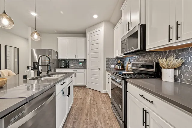a kitchen with microwave cabinets and stove top oven