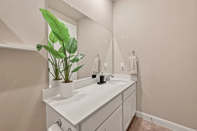 a spacious bedroom with a bed a table and chair