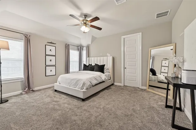 a bed room with a bed window and a flat screen tv