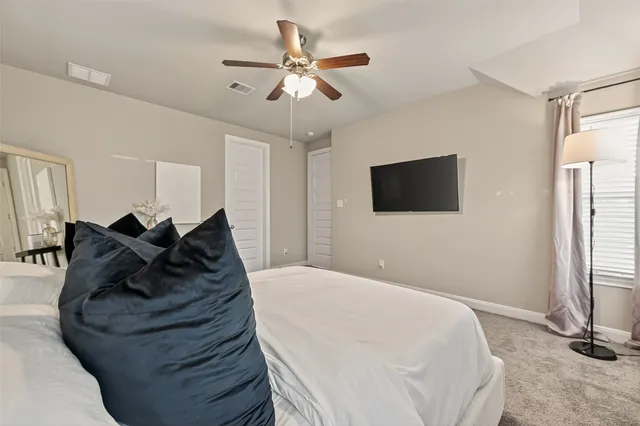 a spacious bathroom with a shower sink and mirror