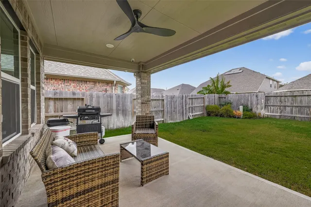 a outdoor living space with patio furniture and a fireplace