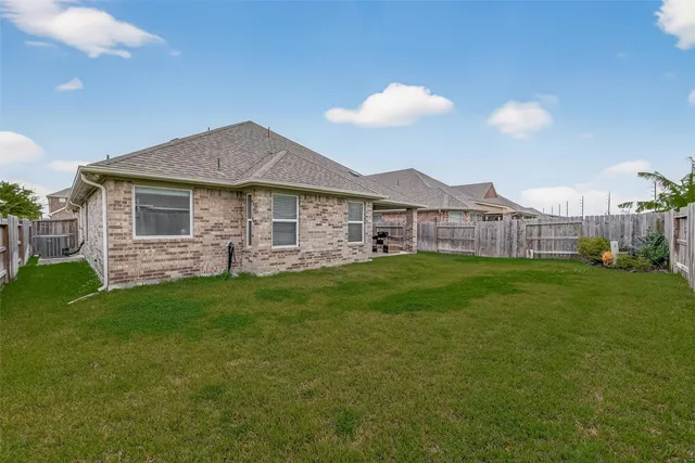 a view of a house with a backyard and a garden