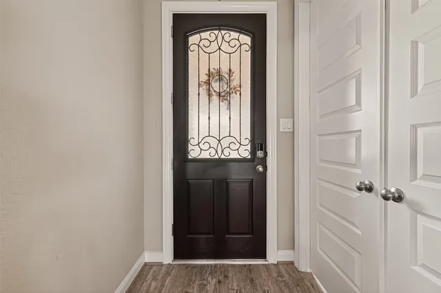 a view of a entryway door with wooden floor