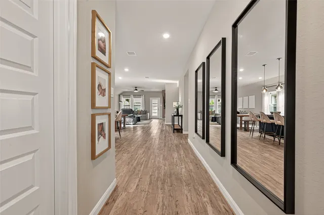 a view of a hallway with wooden floor