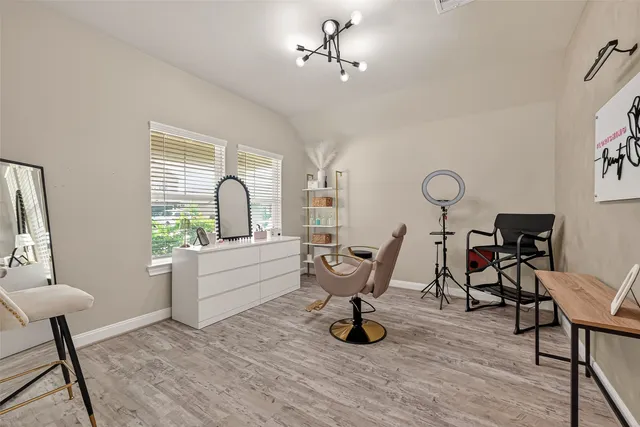 a view of a workspace with furniture and a window