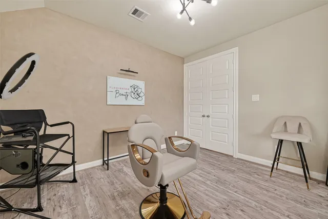 a view of a workspace with furniture and wooden floor