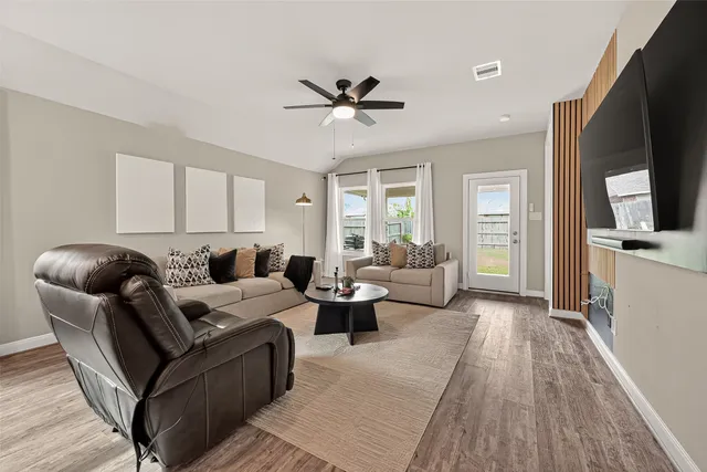 a living room with furniture and a flat screen tv