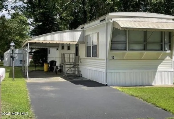a view of a house with a garage and yard