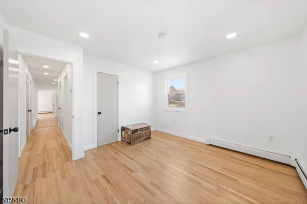 a view of a room with wooden floor and a bathroom