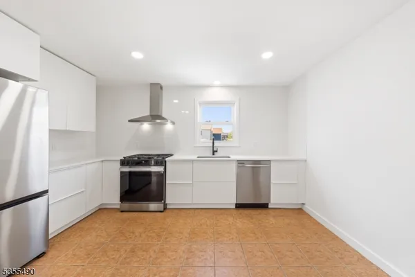 a kitchen with a stove top oven and refrigerator