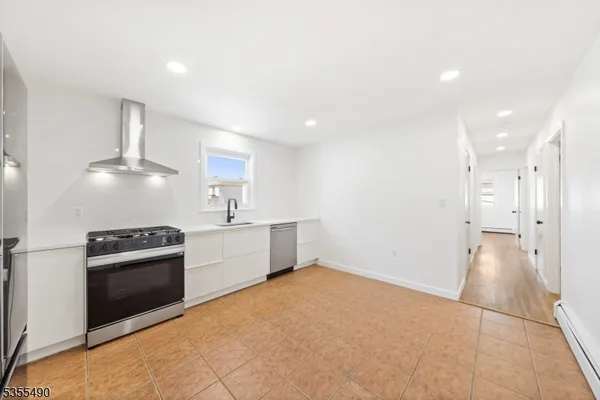 a kitchen with granite countertop a sink and stainless steel appliances