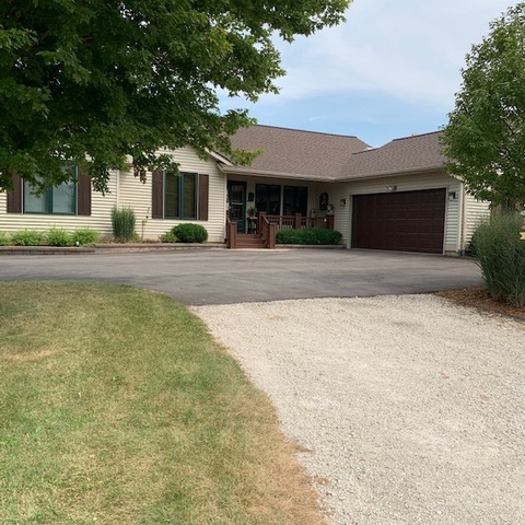27102 East Five Points Road Sycamore, IL 60178 - Photo 1 of 1 a front view of house with yard and trees in the background