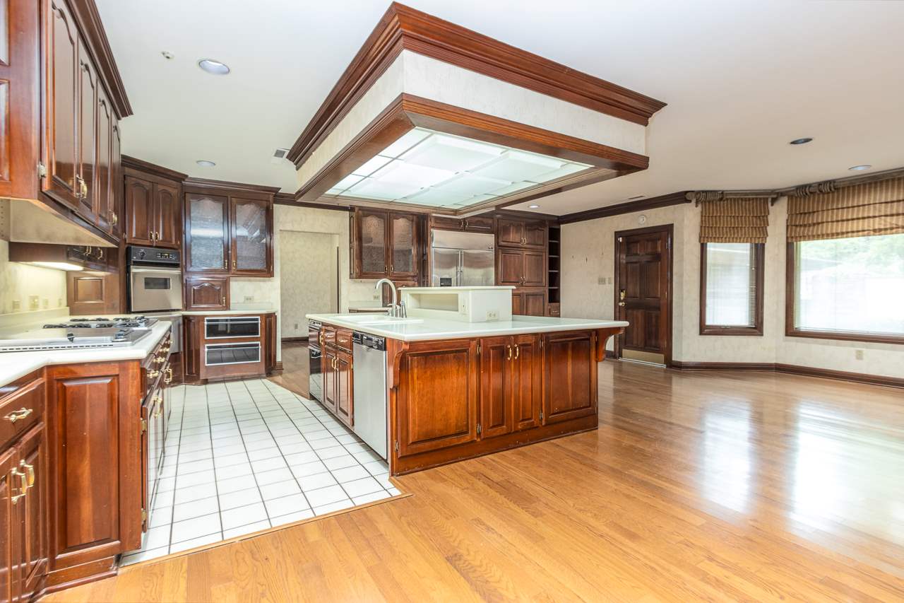 4330 Chickasaw Road Memphis, TN 38117 - Photo 10 of 25 ABUNDANCE OF BEAUTIFUL CHERRY CABINETS, LARGE ISLAND, WITH MANY CUSTOM FEATURES. SUB-ZERO REFRIGERATOR, STAINLESS STEEL APPLIANCES