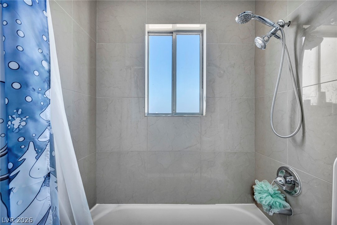 5882 Rio Tinto Way Las Vegas, NV 89110 - Photo 20 of 56 A windowed shower-tub combination provides refreshing functionality to this bathroom.
