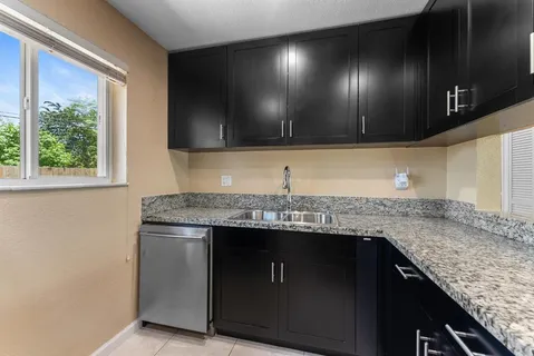 a kitchen with granite countertop stainless steel appliances microwave and cabinets