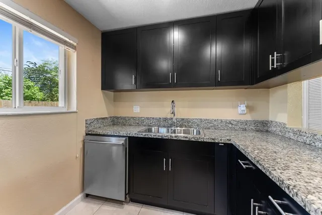 a kitchen with granite countertop stainless steel appliances microwave and cabinets