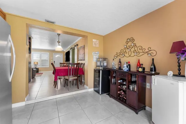 a view of a dining room with furniture and a chandelier