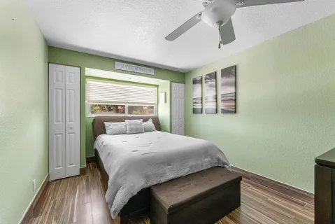 a bedroom with a bed and wooden floor