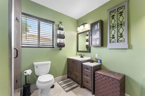 a bathroom with a toilet a sink and a mirror