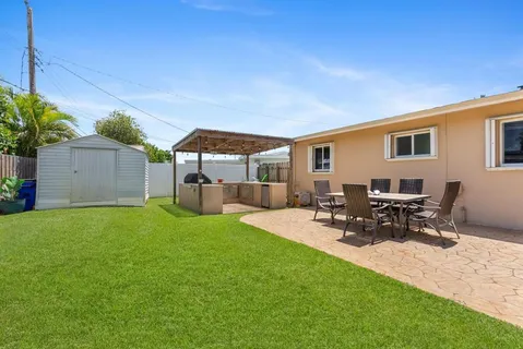 a view of a patio with a table and chairs